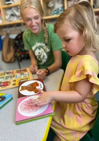teacher and child reading at daycare